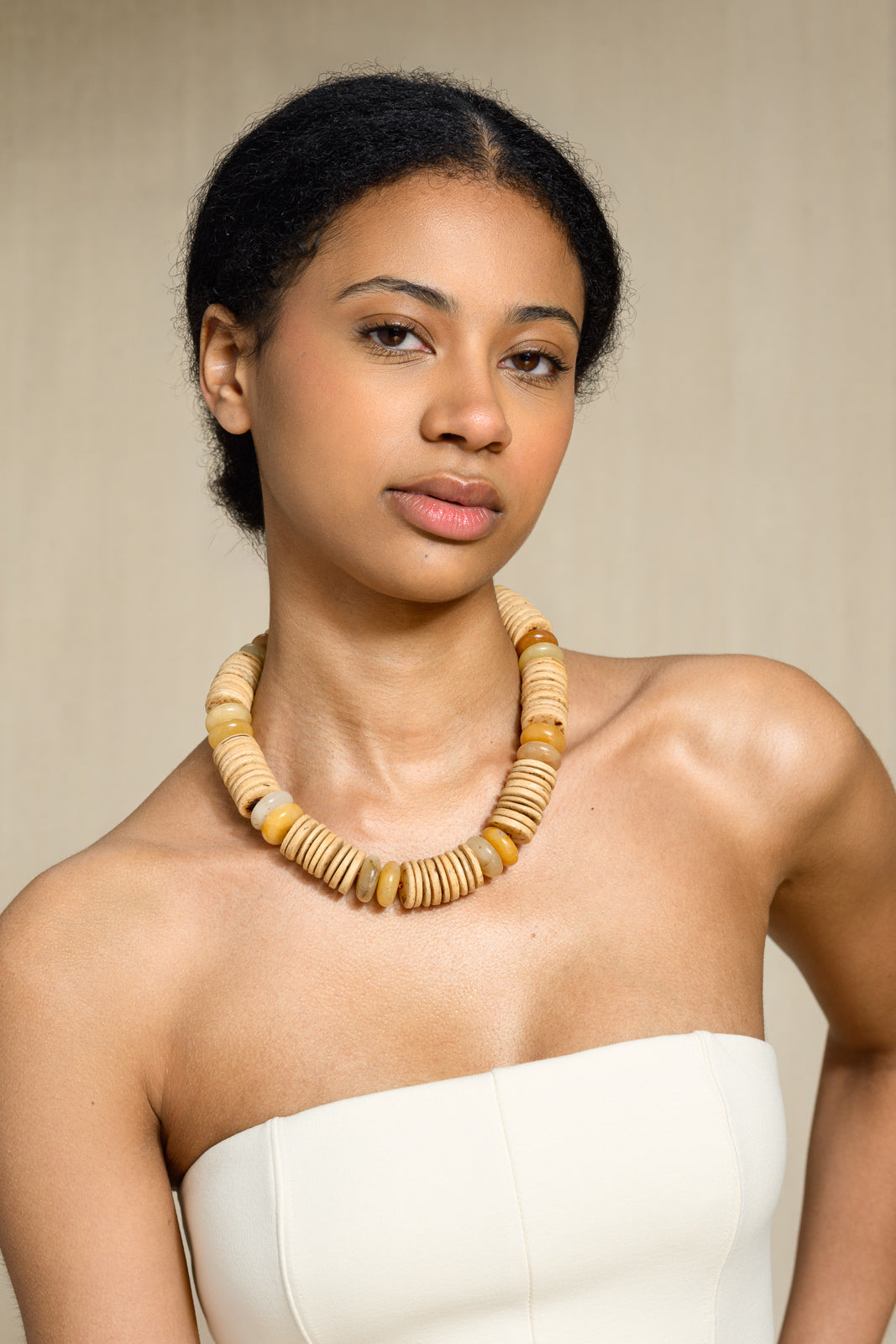Low Tide necklace on model — light coconut and yellow jade