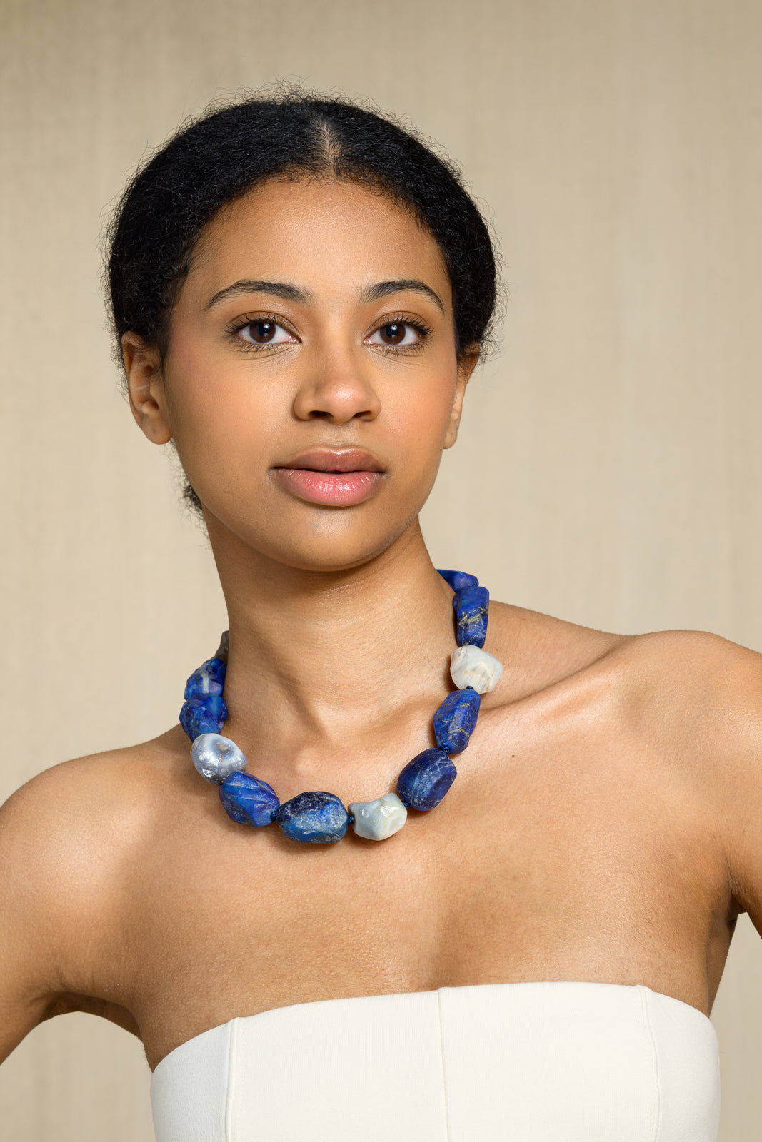 Blue Hole necklace on model — deep lapis lazuli and Botswana agate
